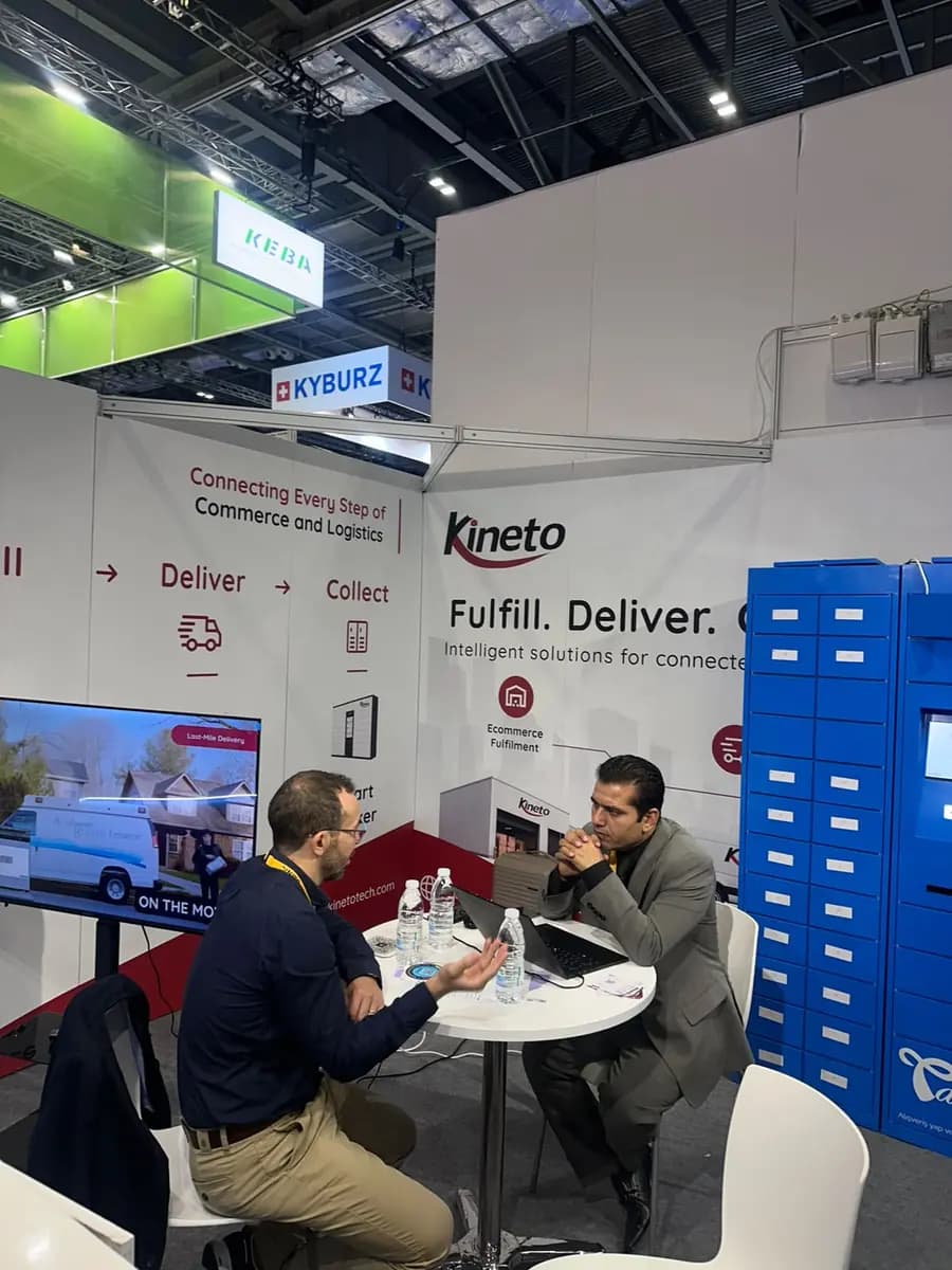 Kineto team working at the booth beside smart lockers at Parcel+Post Expo London 2026