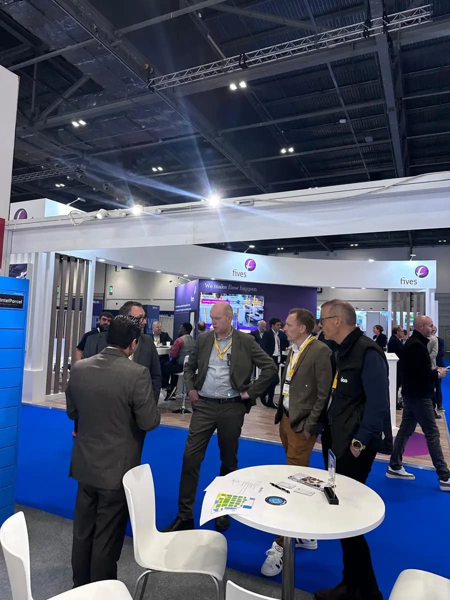 Visitors talking with the Kineto team in the exhibition hall at Parcel+Post Expo London 2026