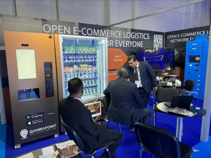 Visitors at coffee and snack vending machines on the Kineto booth at Seamless Middle East